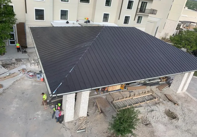 Metal roofing installation team working on a commercial building in Hilton Head Island